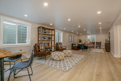 Finished basement with stylish waterproof flooring and cozy furniture